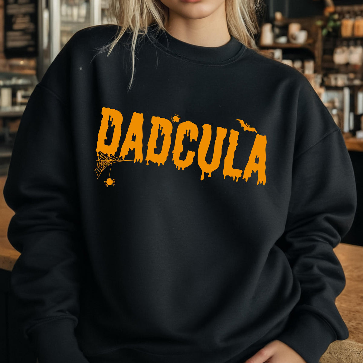 May include: Black sweatshirt with an orange graphic that says "DADCULA" with a spider web and bat design.