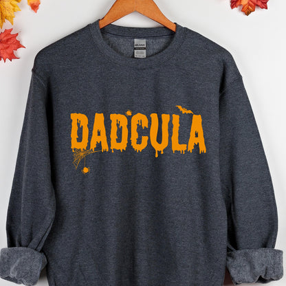 May include: A dark gray sweatshirt with the text "DADCULA" in orange dripping letters. The text is accompanied by a small spider web and a bat.