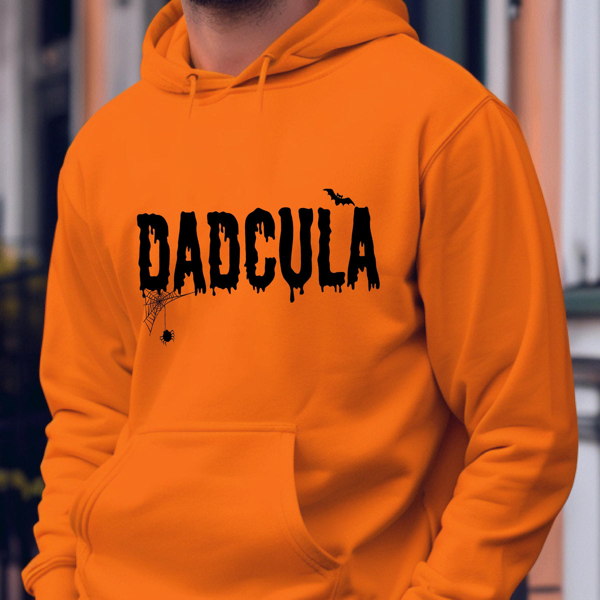 May include: Orange hoodie with a black graphic that says "DADCULA" with a spider web and bat design.
