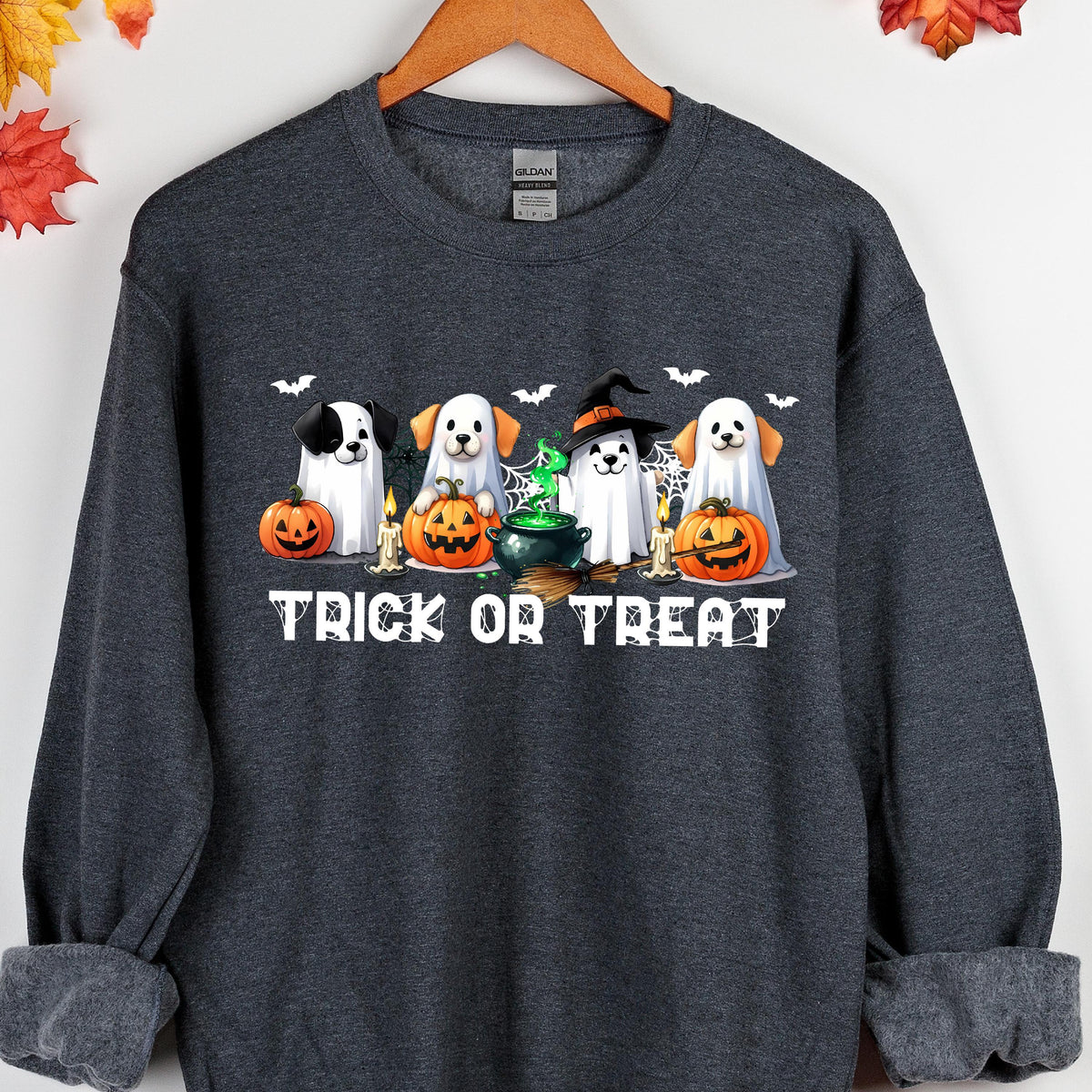 May include: Dark gray sweatshirt with a Halloween-themed graphic. The graphic features cartoon dogs dressed as ghosts, holding jack-o'-lanterns, and the text "Trick or Treat". Bats and candles are also included in the design.