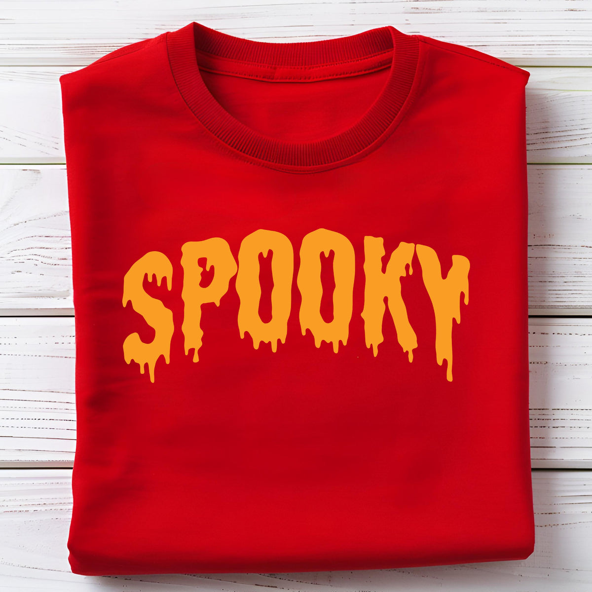 May include: A folded red sweatshirt with the word "SPOOKY" in dripping orange letters. The sweatshirt is made of a soft material and is perfect for Halloween or spooky season.
