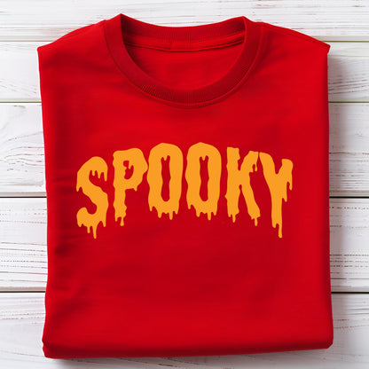 May include: A folded red sweatshirt with the word "SPOOKY" in dripping orange letters. The sweatshirt is made of a soft material and is perfect for Halloween or spooky season.