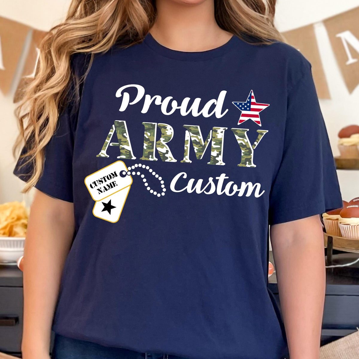 May include: Navy blue t-shirt with the words "Proud ARMY Custom" in white and camouflage lettering. An American flag star graphic and a dog tag design with the text "CUSTOM NAME" are also featured.