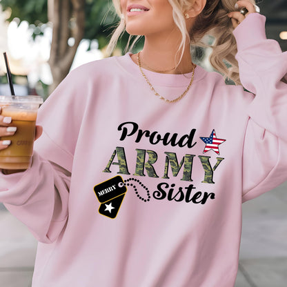 May include: A light pink sweatshirt with the words "Proud ARMY Sister" in black and camouflage green. An American flag star graphic and a dog tag graphic are also featured on the front.