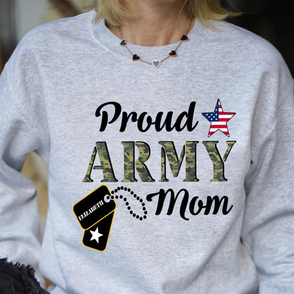 May include: Light gray sweatshirt with the text "Proud ARMY Mom" in black script and camouflage print. Features a star with an American flag design and a dog tag with the name "Elizabeth".