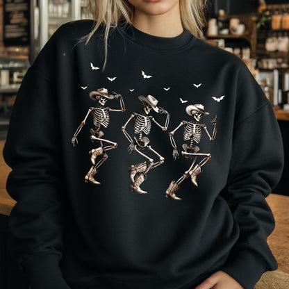 May include: Black sweatshirt featuring a graphic of three dancing skeletons wearing cowboy hats and boots. White bats are scattered across the top. The skeletons are in various dance poses, with detailed bone structures.
