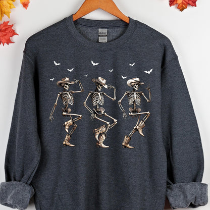 May include: Dark gray sweatshirt featuring a graphic of three dancing skeletons wearing cowboy hats and boots. White birds are scattered across the top. The sweatshirt has a crew neck and long sleeves.