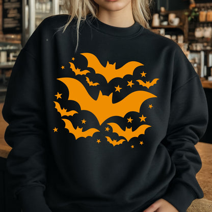May include: Black sweatshirt featuring a Halloween design. The design includes orange bats and stars. The bats are in various sizes and orientations, creating a dynamic and festive pattern. The sweatshirt is a crew neck style.