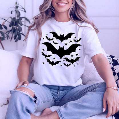 May include: White t-shirt featuring a black bat and star design. The graphic includes several bats of varying sizes and small stars, creating a Halloween-themed pattern. The shirt is a classic crew neck style.