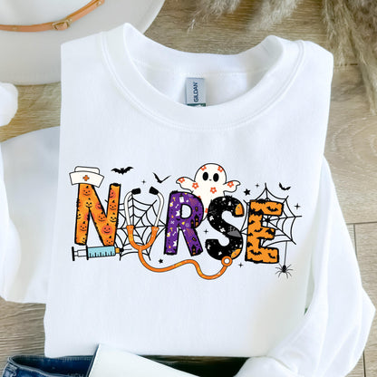 May include: White sweatshirt with the word "NURSE" in a Halloween-themed design. The letters are decorated with pumpkins, a ghost, spiderwebs, and a stethoscope. A syringe and bats are also included in the design.