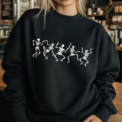 May include: Black sweatshirt featuring a white graphic of dancing skeletons. The skeletons are in a row, with their arms and legs in various positions, giving the impression of movement. The design is centered on the front of the sweatshirt.