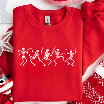 May include: A red crewneck sweatshirt featuring a white graphic of six dancing skeletons. The skeletons are in various poses, with their arms and legs outstretched. The sweatshirt is made of a soft material.