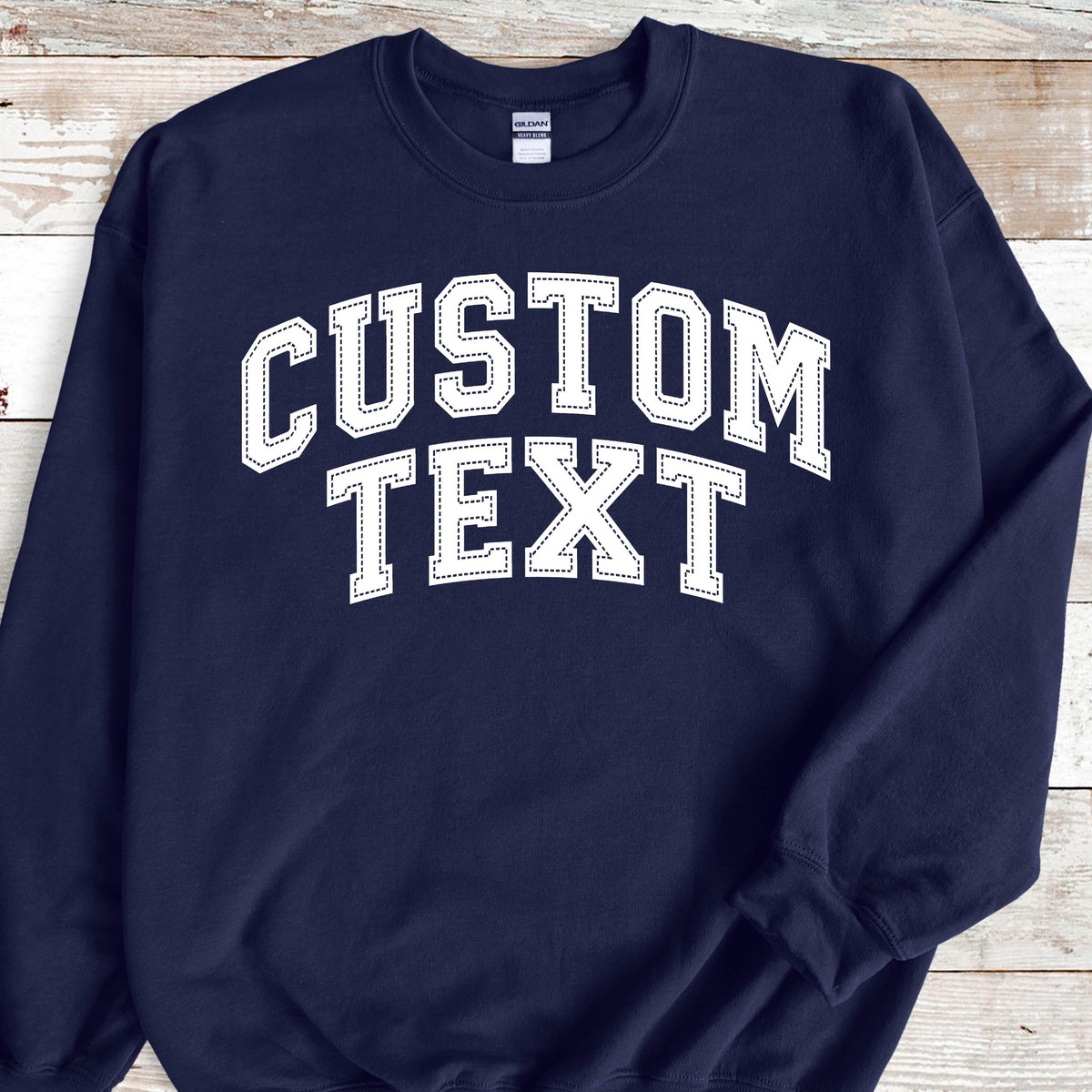 May include: Navy blue sweatshirt with white text that reads "CUSTOM TEXT" in a varsity style font.