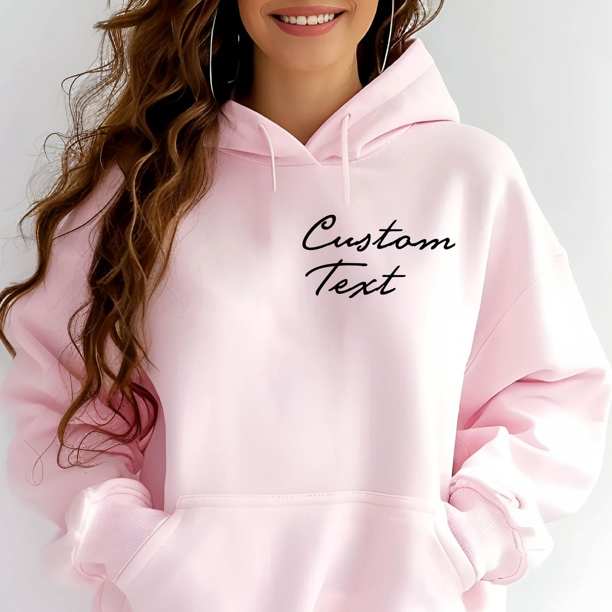 May include: A pink hoodie with a black cursive text that says "Custom Text" on the front.