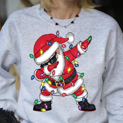 May include: A gray sweatshirt with a cartoon image of Santa Claus wearing sunglasses and tangled in Christmas lights. Santa is in a dabbing pose.