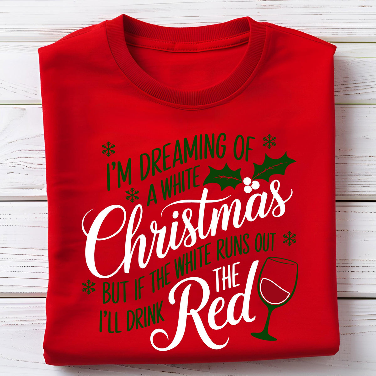 May include: A red sweatshirt with the text "I'm dreaming of a white Christmas, but if the white runs out, I'll drink the red." The design includes snowflakes, holly, and a wine glass.