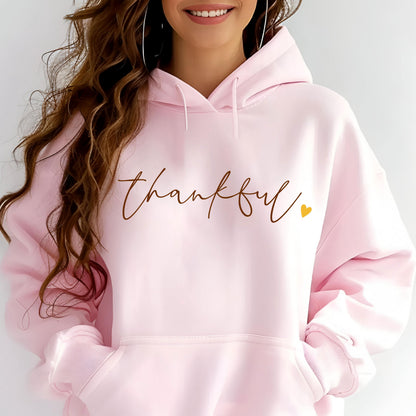 May include: A pink hoodie with the word "thankful" written in brown cursive lettering and a small gold heart.