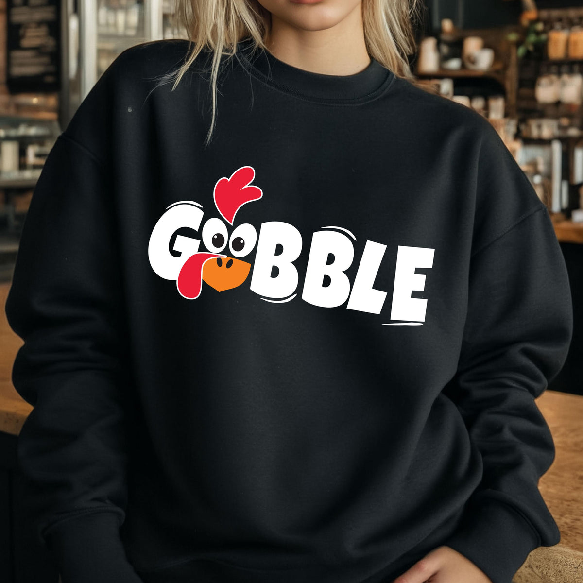 May include: Black sweatshirt with a white graphic of a turkey with the word "GOBBLE" printed on it.