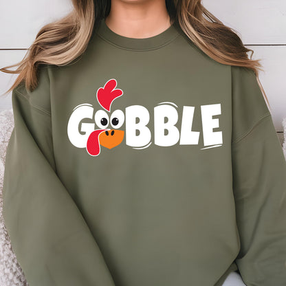 May include: A green sweatshirt with a white graphic of a turkey head and the word "GOBBLE" in white letters.