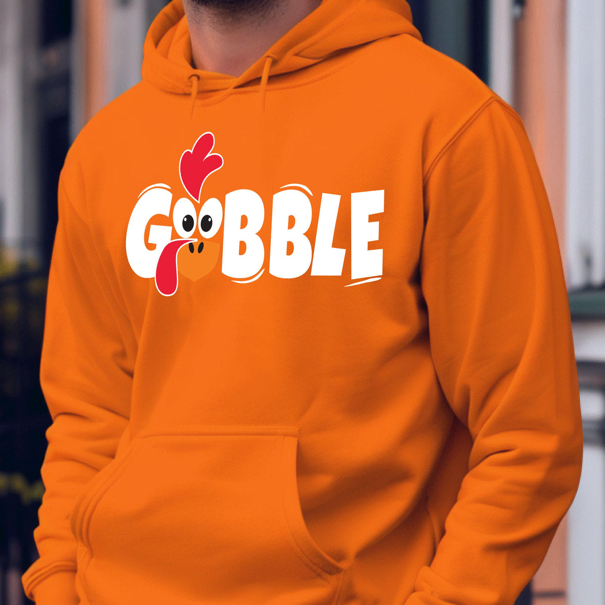 May include: Orange hoodie with a white graphic of a turkey head and the word "GOBBLE".