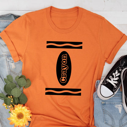 May include: Orange t-shirt with a black and white crayon design. The crayon is labeled "Crayon".