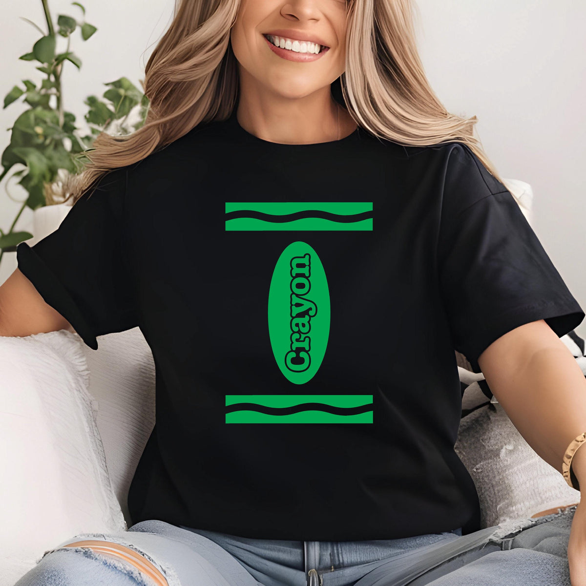 May include: A black t-shirt with a green crayon design. The crayon is labeled "Crayon" in white text.