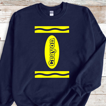 May include: A navy blue sweatshirt with a yellow crayon design. The crayon is outlined in white and the word "Crayon" is written vertically inside the crayon.