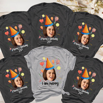 May include: Six gray and light gray t-shirts with a birthday theme. Each shirt features a different person's face with a party hat and confetti. One shirt says "i am merry".