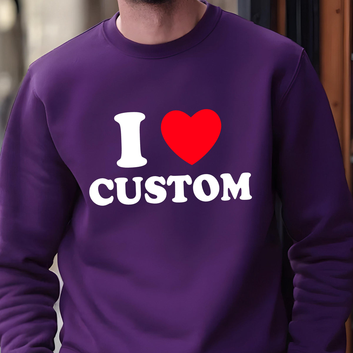 May include: A purple sweatshirt with the text "I ♥ CUSTOM" in white and a red heart. The sweatshirt is a solid color and has a crew neck.