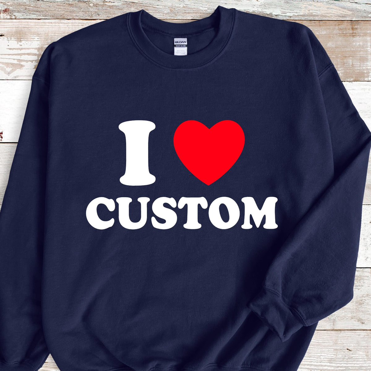 May include: Navy blue sweatshirt with the text "I ♥ CUSTOM" in white and a red heart. The sweatshirt is a crew neck style.