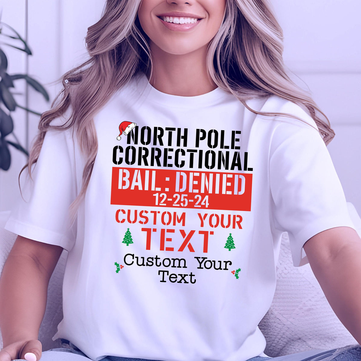 May include: White t-shirt with the text "NORTH POLE CORRECTIONAL BAIL: DENIED 12-25-24 CUSTOM YOUR TEXT". The design includes a Santa hat, a red banner, green Christmas trees, and holly.