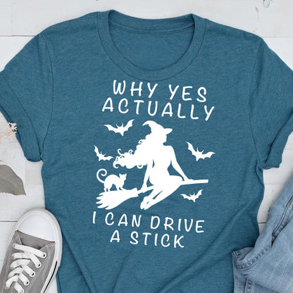 May include: Teal t-shirt with a white graphic of a witch on a broom, a black cat, and bats. The text reads "WHY YES ACTUALLY I CAN DRIVE A STICK."
