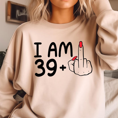 May include: A beige sweatshirt with the text "I AM 39+" and a cartoon hand giving the middle finger.