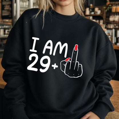May include: Black sweatshirt with white text that reads "I AM 29+" and a white silhouette of a hand giving the middle finger with red nail polish.