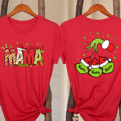 May include: A red t-shirt featuring a graphic on the front that spells MAMA in patterned letters with a Santa hat and green character accents. The back graphic shows a green hand holding three ornaments with Santa hats and the text Name.
