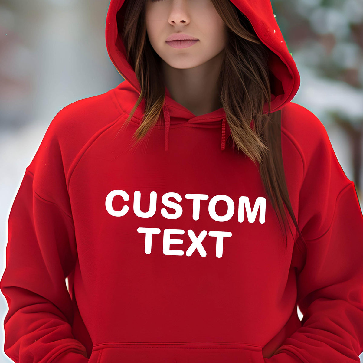 May include: A bright red hooded sweatshirt featuring the words CUSTOM TEXT printed in bold white capital letters across the chest. The garment includes a matching red hood with drawstrings and a front kangaroo pocket, providing a simple design.