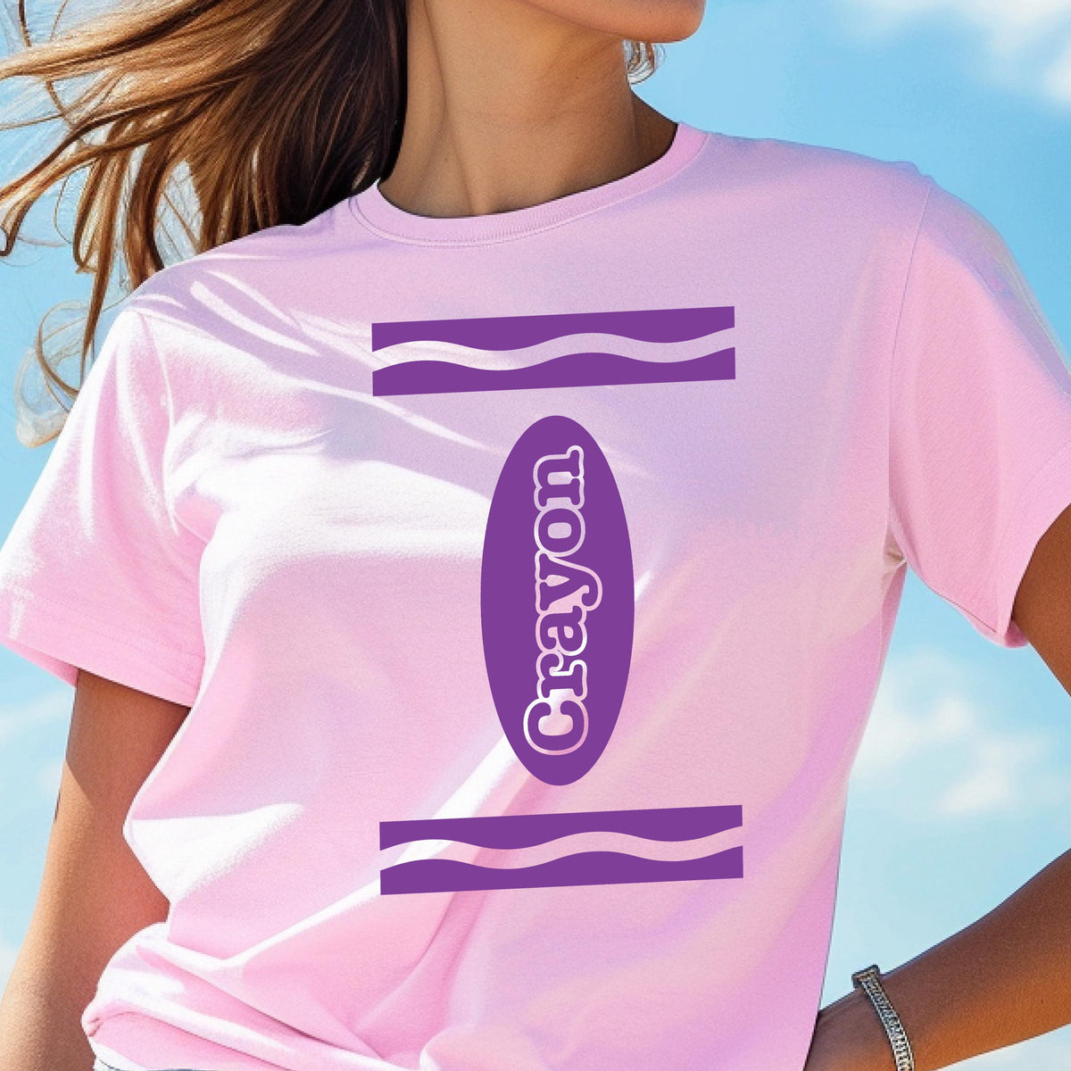 May include: A pink t-shirt with a purple crayon design. The crayon is labeled "Crayon" in white text.