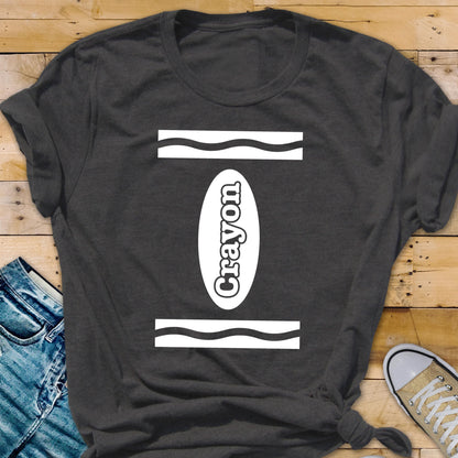 May include: A dark gray t-shirt with a white crayon design. The design features a white oval with the word "Crayon" written inside. The oval is surrounded by two white wavy lines.