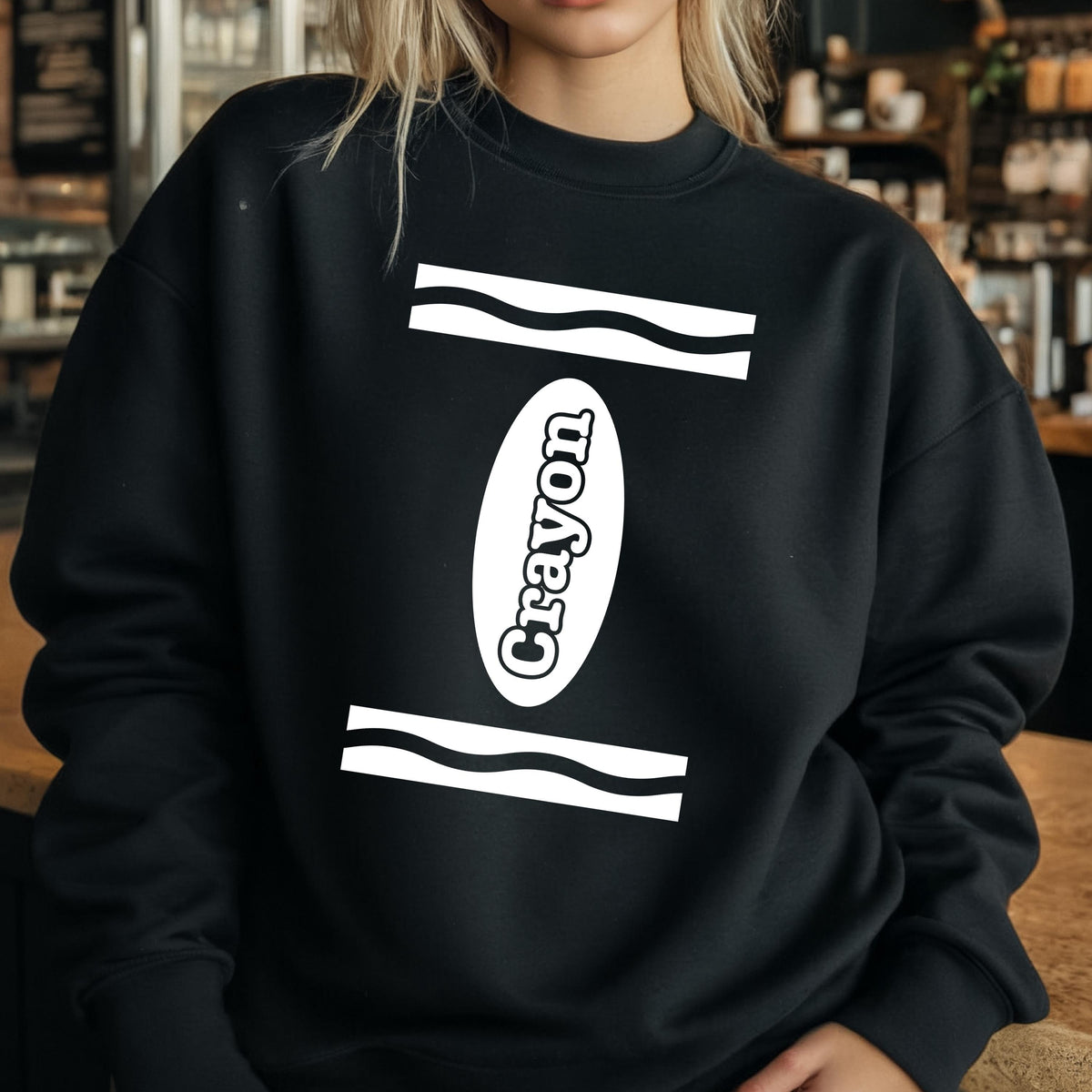May include: Black sweatshirt with a white crayon design. The crayon is outlined in white and has the word "Crayon" written on it.