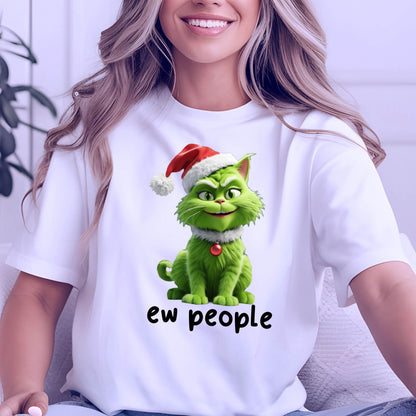 May include: A white short-sleeved t-shirt featuring a graphic of a green cat wearing a red and white Santa hat and a small red ornament collar. Below the cat, the text "ew people" is printed in a simple black sans-serif font.