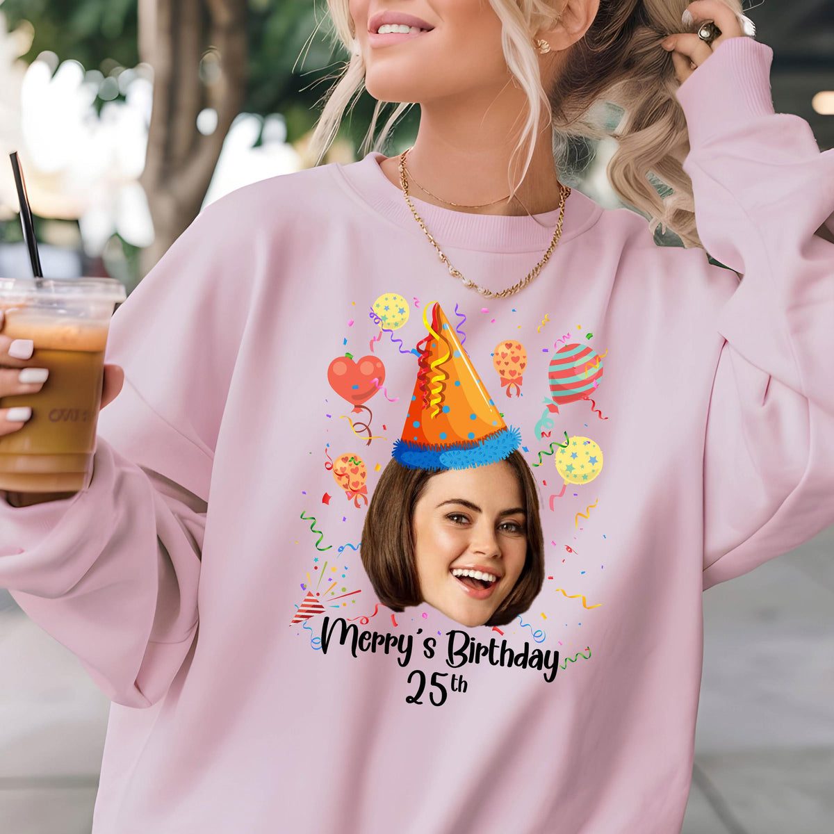 May include: Pink sweatshirt with a personalized photo of a person wearing a party hat and surrounded by confetti and balloons. The text "Merry's Birthday 25th" is printed below the photo.