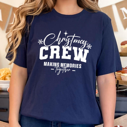 May include: A navy blue short-sleeve t-shirt featuring white text that reads Christmas CREW MAKING MEMORIES Together, accented with small white snowflake icons and a star symbol above the word Christmas, centered on the chest.
