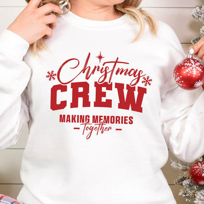 May include: A white long-sleeve sweatshirt featuring red text that reads Christmas CREW MAKING MEMORIES -Together- with small red snowflake and star accents. The design is centered on the chest of the garment, which has a crew neckline.