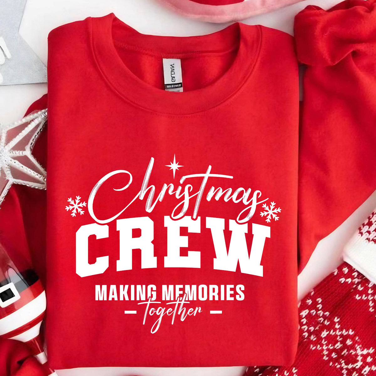 May include: A bright red crewneck sweatshirt featuring white screen-printed text that reads Christmas CREW MAKING MEMORIES Together, accented with small white snowflake graphics on the left and right sides of the word Christmas.