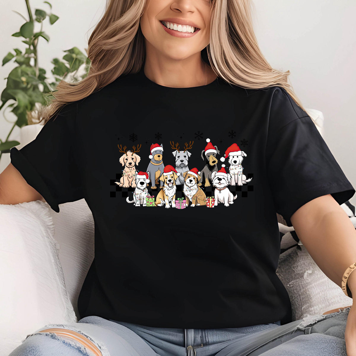 May include: Black t-shirt featuring a festive design of various dog breeds wearing Santa hats and reindeer antlers. The dogs are arranged in a row, with gifts and snowflakes above them. The shirt has a classic crew neck.
