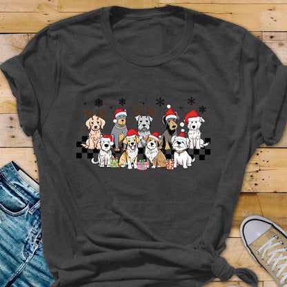 May include: Dark gray t-shirt featuring a festive graphic of various dog breeds wearing Santa hats and reindeer antlers. The dogs are arranged in a row with snowflakes and gift boxes, creating a holiday theme.