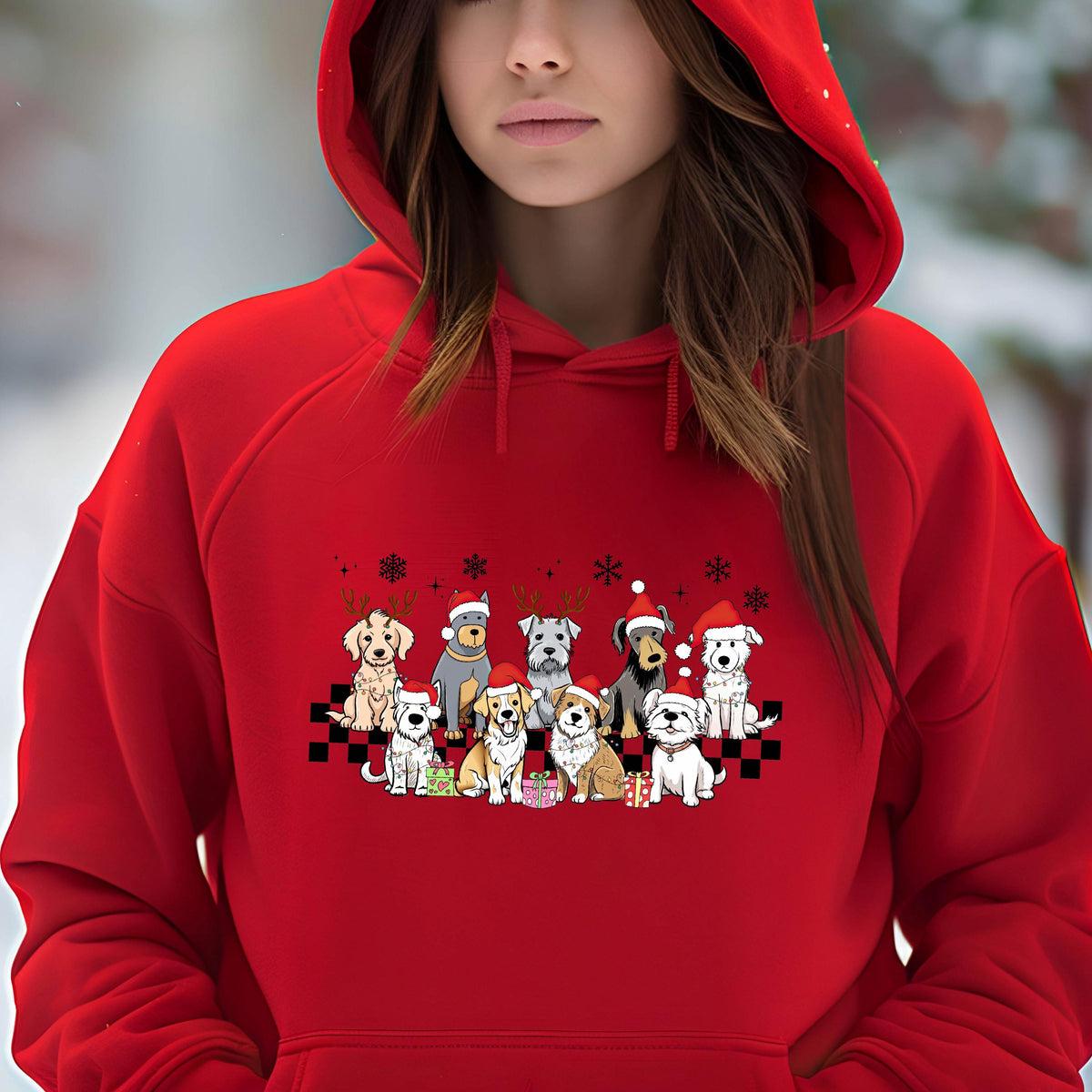 May include: A red hooded sweatshirt featuring a graphic of various dog breeds wearing Santa hats and reindeer antlers. The dogs are arranged in two rows on a black and white checkered pattern, with snowflakes above.