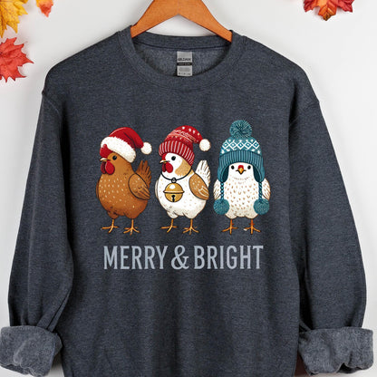 May include: A dark gray sweatshirt with a Christmas-themed design featuring three chickens wearing Santa hats and winter beanies. The text "Merry & Bright" is printed below the chickens.
