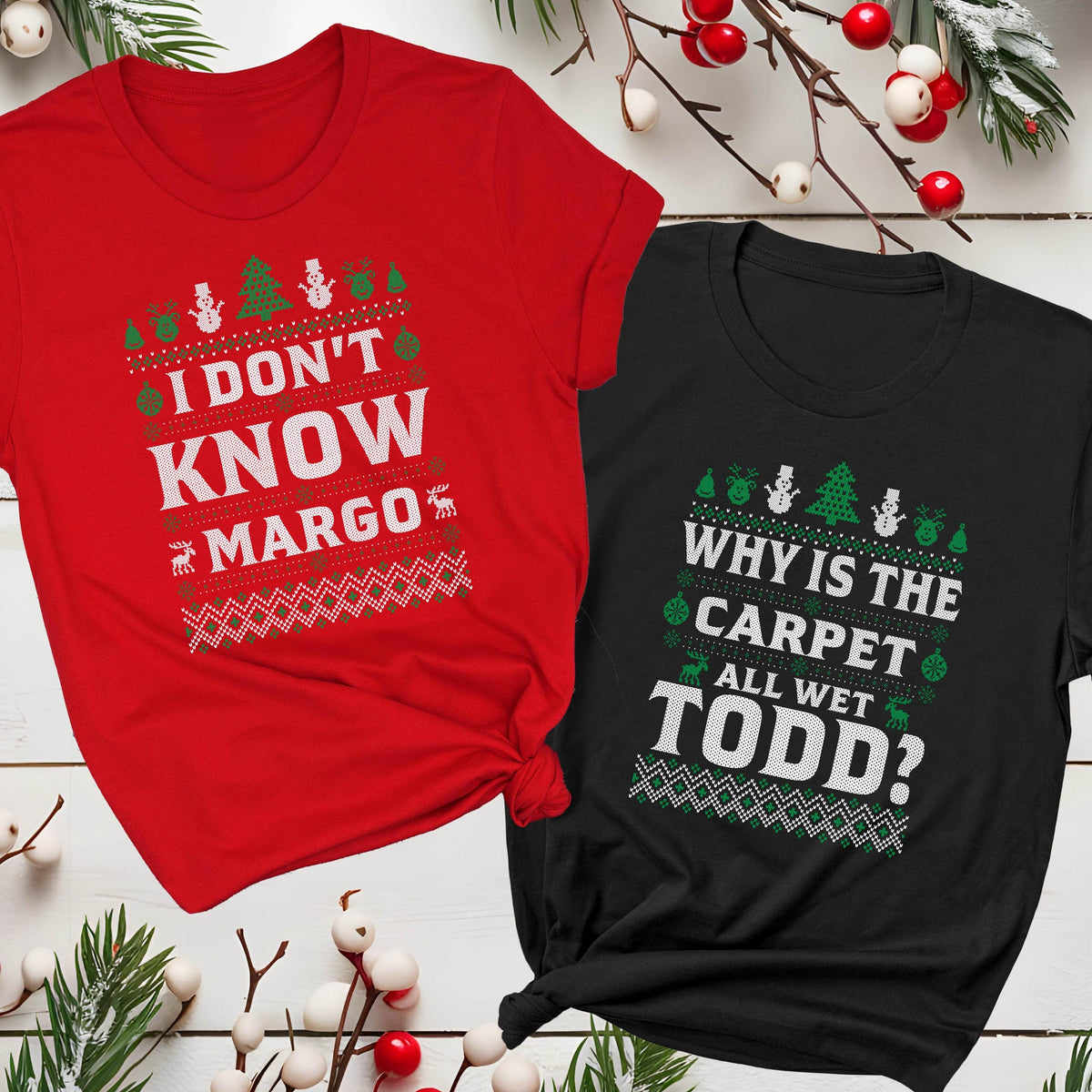 May include: Two Christmas-themed t-shirts. One is red with the text "I DON'T KNOW MARGO" and the other is black with the text "WHY IS THE CARPET ALL WET TODD?". Both shirts have a festive design with trees, snowmen, and reindeer.