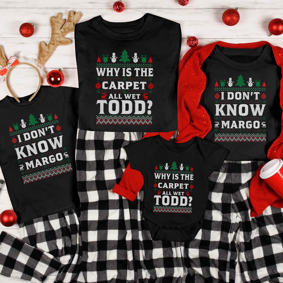 May include: Black family matching Christmas pajamas with the phrases "I DON'T KNOW MARGO" and "WHY IS THE CARPET ALL WET TODD?" printed on the shirts. The pajamas have a festive sweater design with Christmas trees and ornaments.